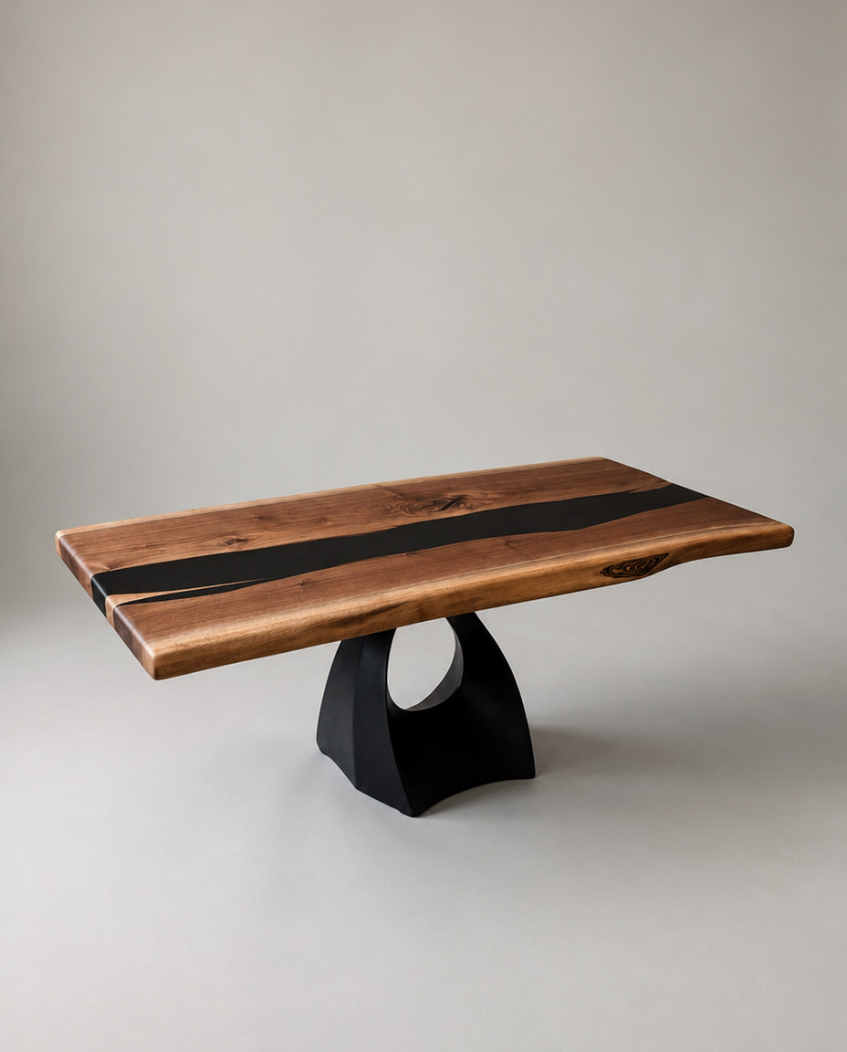 The Gaspee Coffee Table, live edge black walnut with a black epoxy inlay on a curved steel pedestal base, photographed in the studio