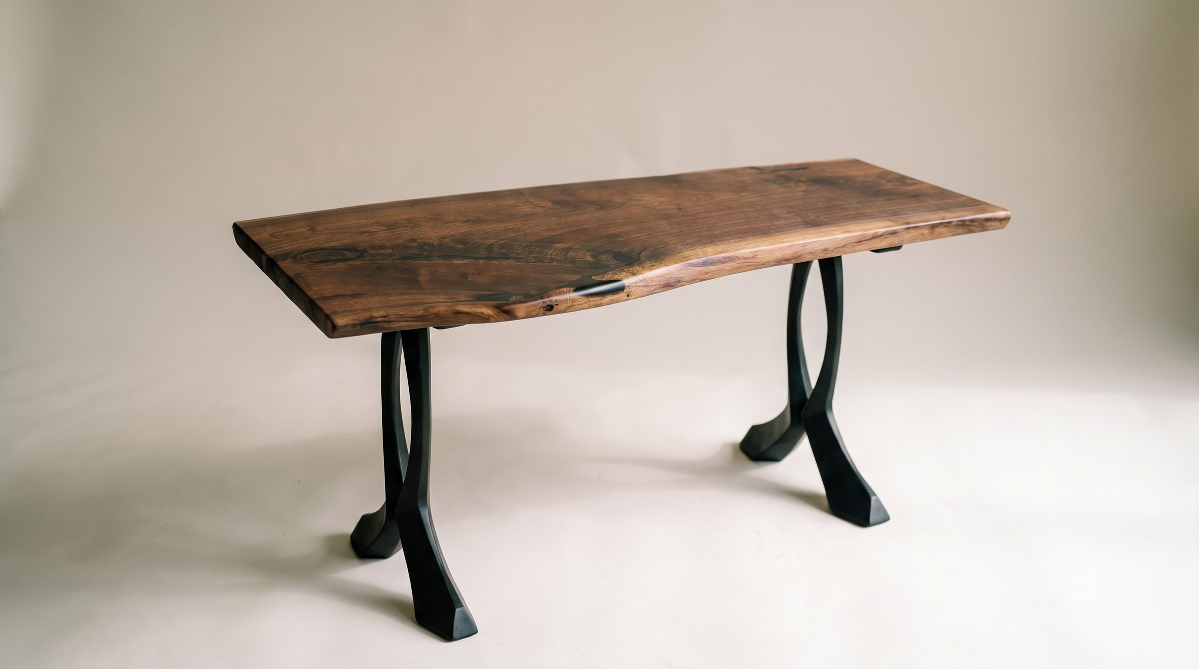 The Blackstone Console Table, a live edge black walnut top on black Curva steel legs.