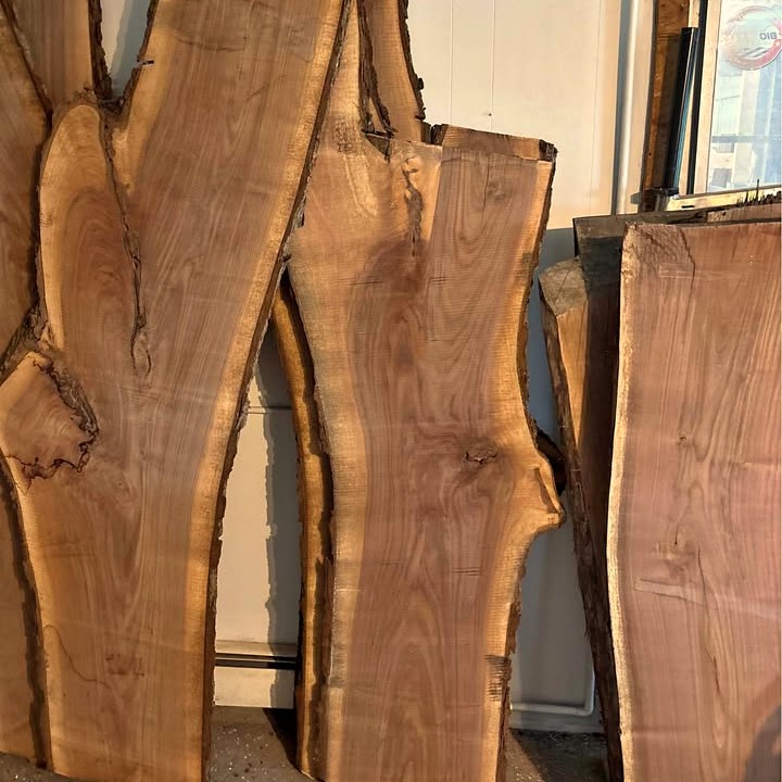 Black walnut slabs stood on edge against the shop wall, the choices I pull for a piece.